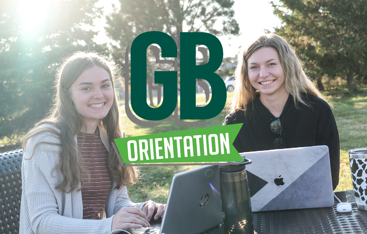 UWGB students studying outside with GB Orientation graphic.