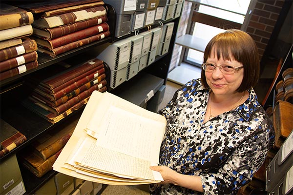 Archivist Deb Anderson with collections