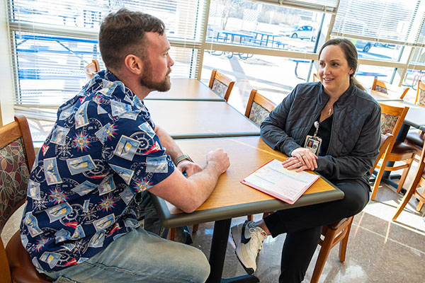 Interviewing man and woman at table