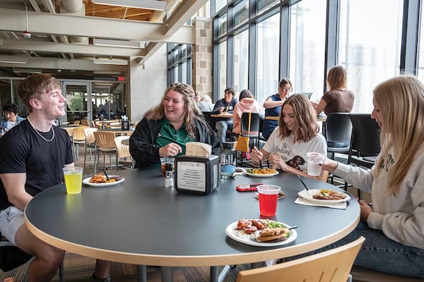 Group of students have lunch together at the Cloud Commons