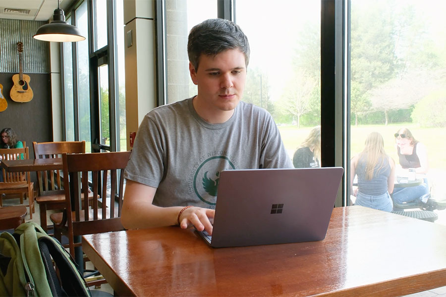 UWGB MPA student Gage Beck works on a laptop in the Union.