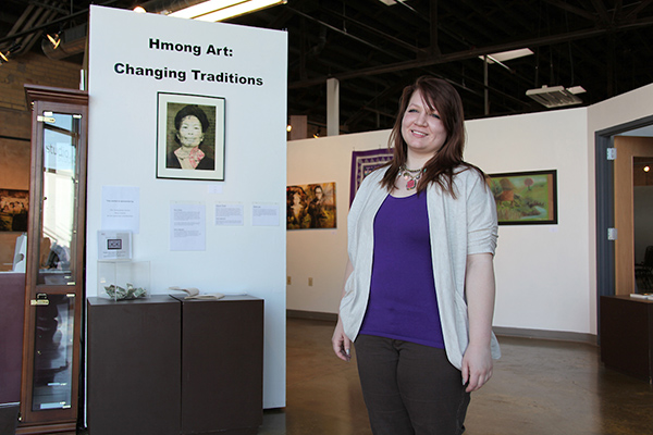 Artist in front of her work in gallery