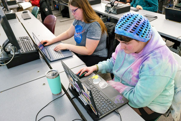 Two female students working at lab tops