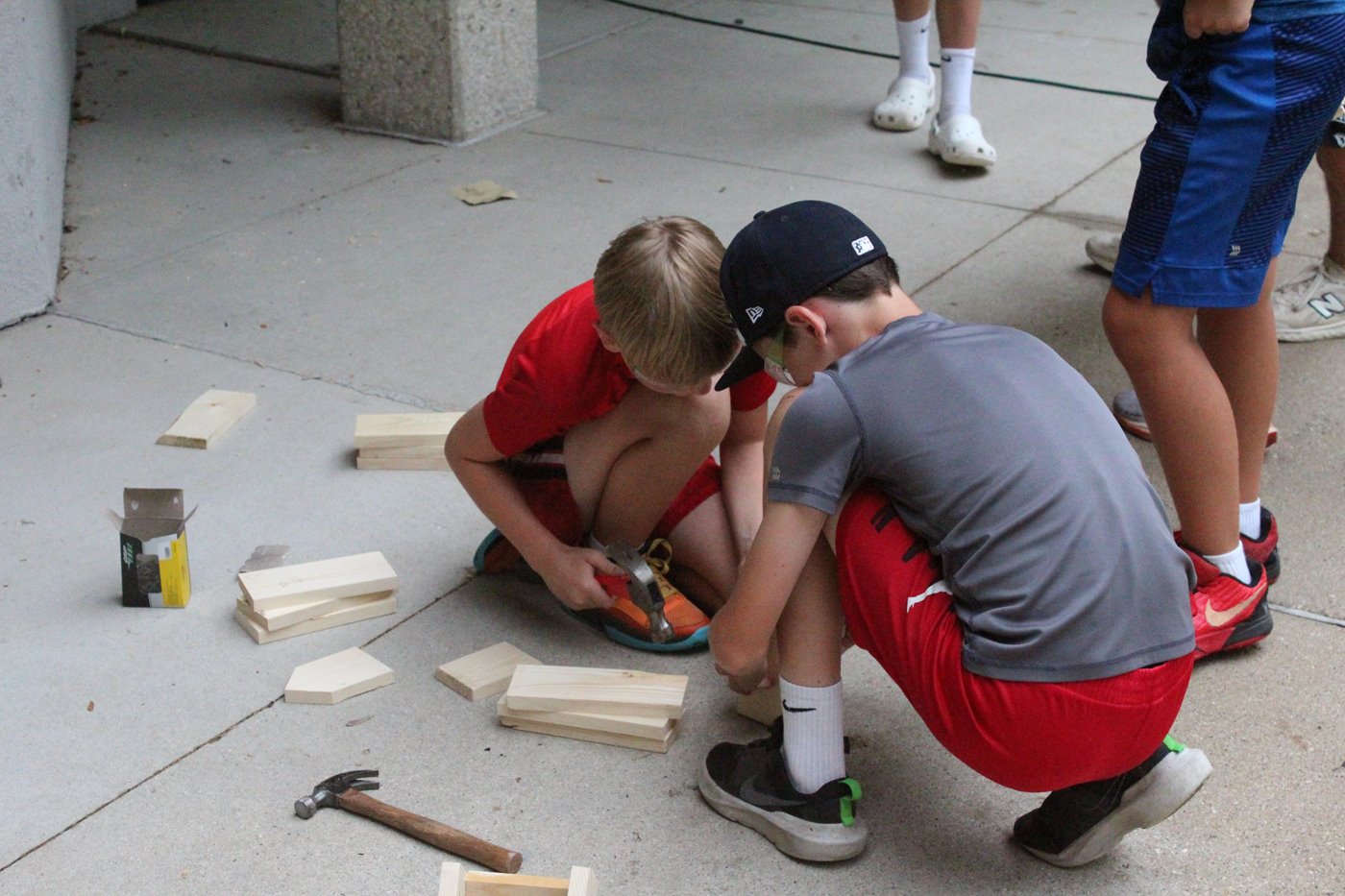 Campers building birdhouses out of wood
