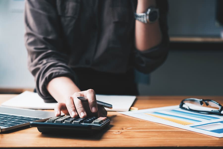 Student using calculator to figure out costs