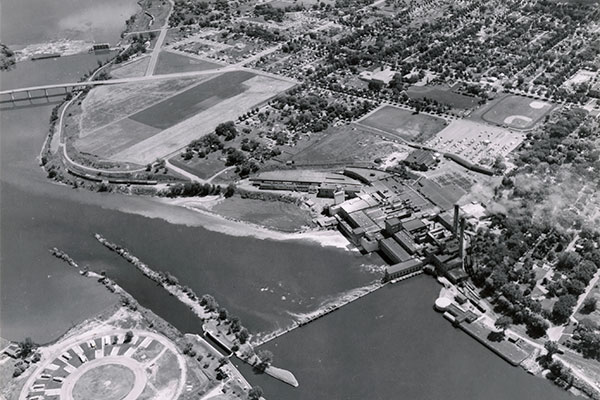 August 1958 aerial photo of a paper mill dumping waste into the Fox River