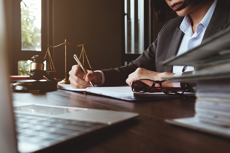 Working at desk with laptop in lawyer office