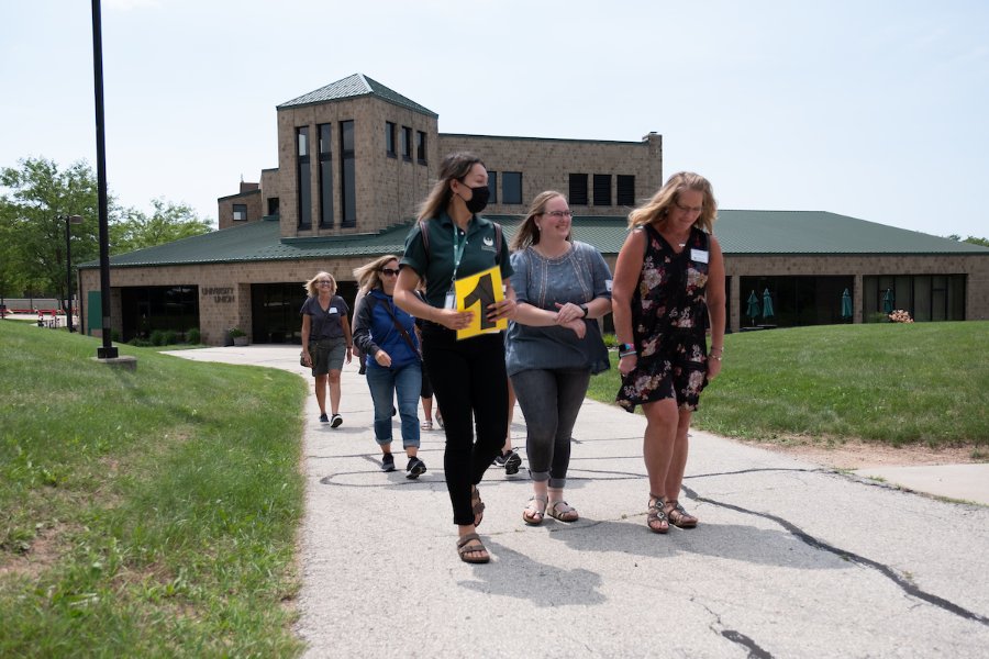 Families walk with a tour guide departing from the University Union at GB Orientation.