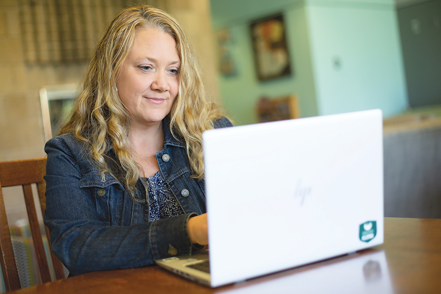 Rhonda Fisher working on her laptop from home