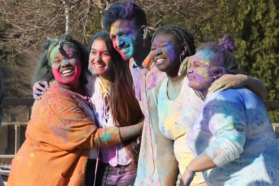 Students hug at Indian Holi Festival event