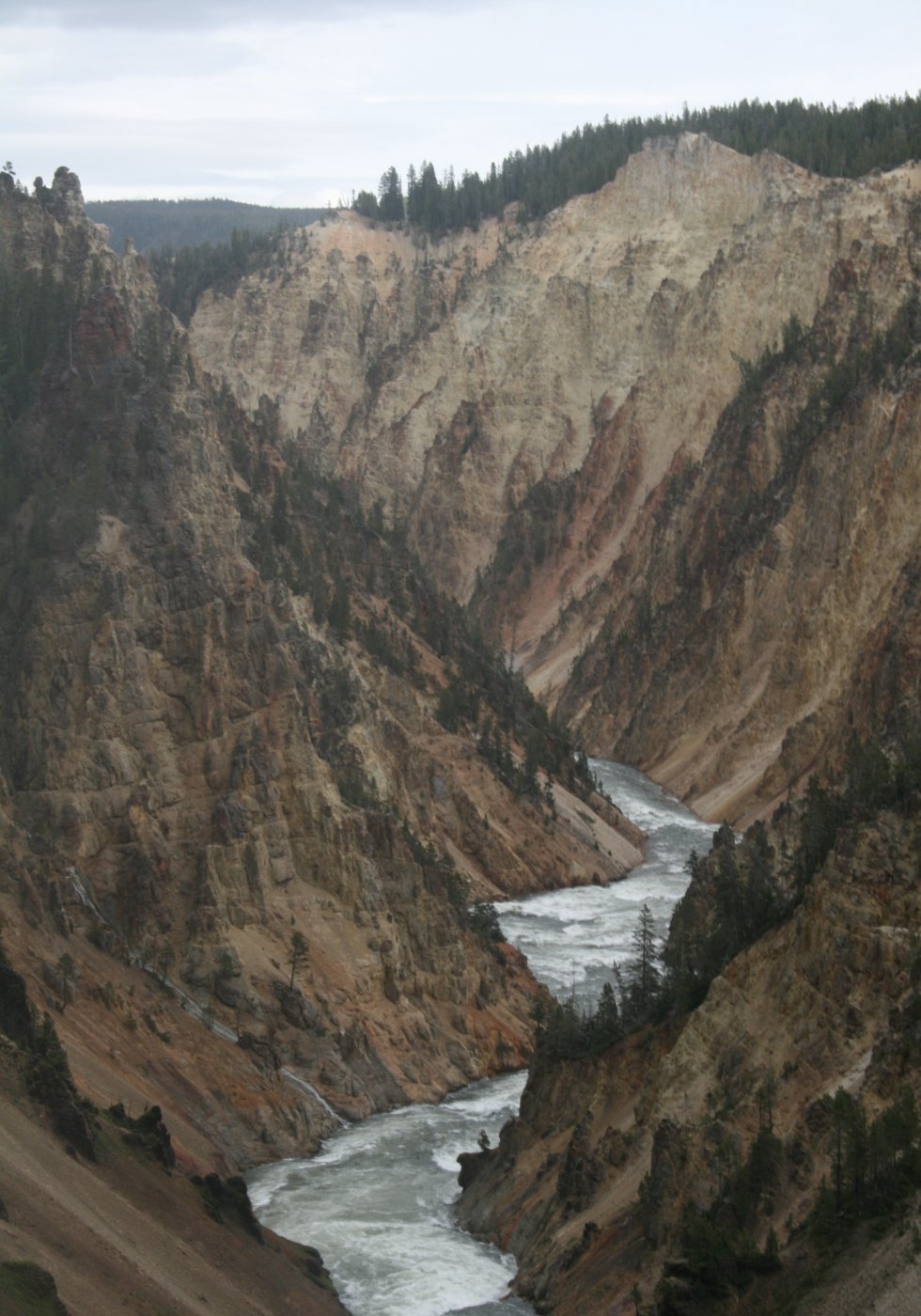 Photo of an icy river running through jagged mountains.