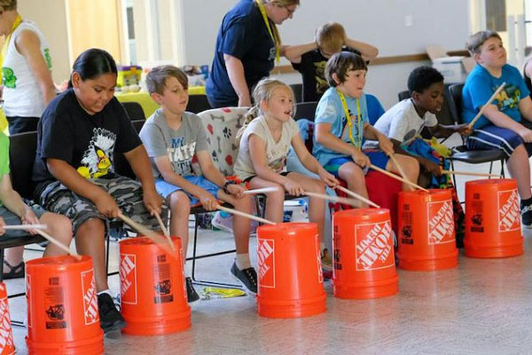 Children drumming on buckets