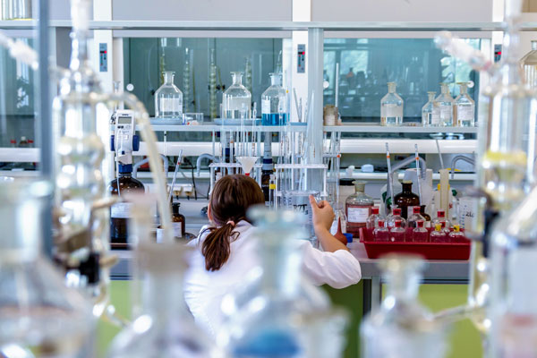 Biochemist working in lab filled with lab instruments