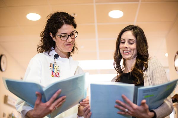 Two nurse administrators look over documents