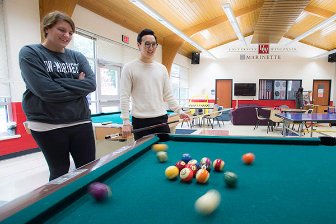 Two students playing pool