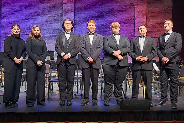 Student musicians posing on stage