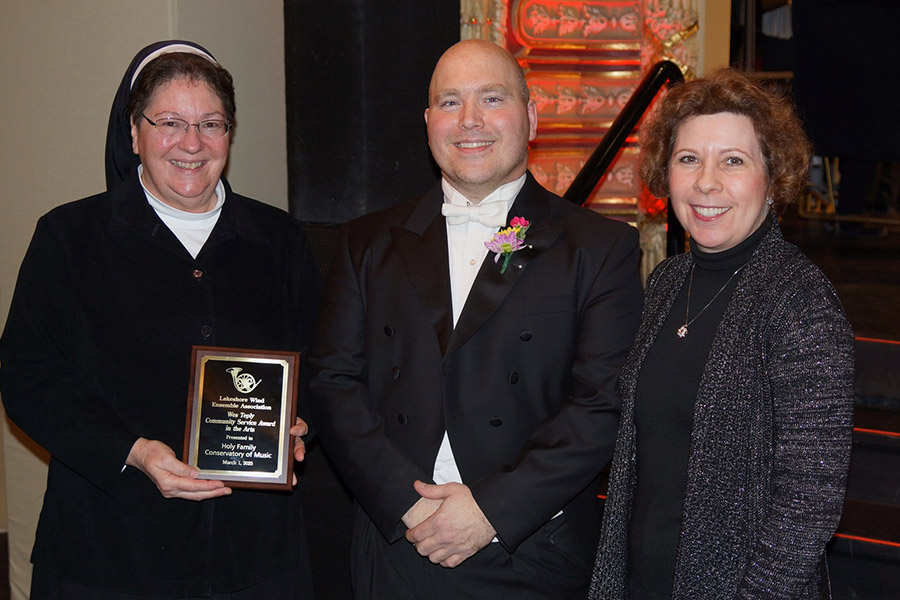 Award recipients with band conductor