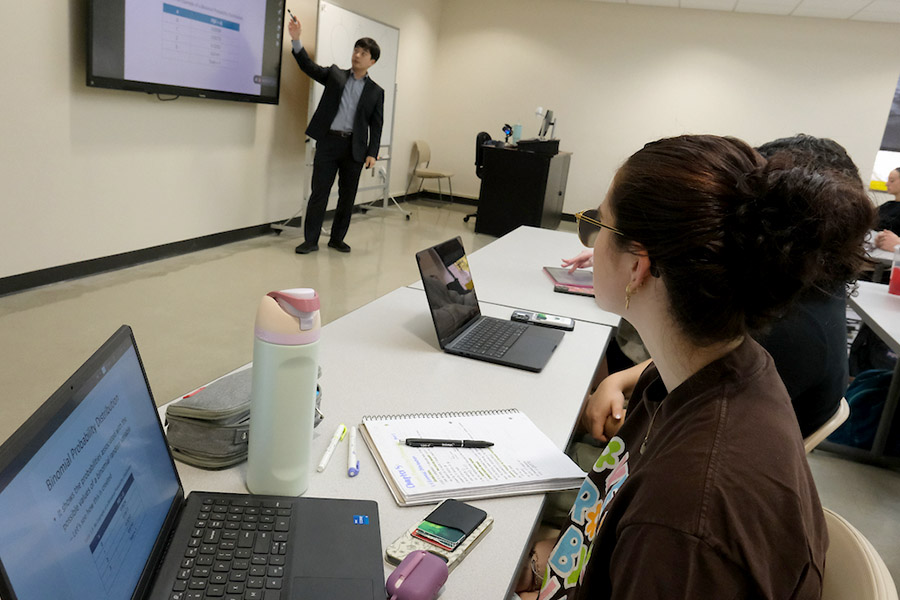Professor at front of class giving a presentation