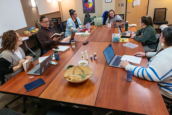 First Nations students meet as a group in a classroom.
