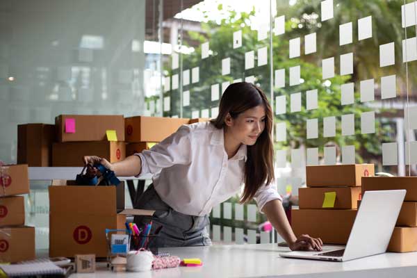 Female entrepreneur prepares orders for shipment