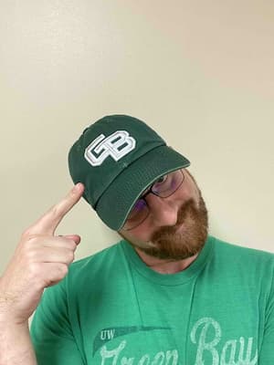 Male wearing UW-Green Bay hat