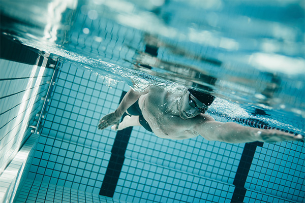 Person swimming laps in an indoor pool