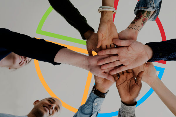hands in team concept with DISC assessment circle