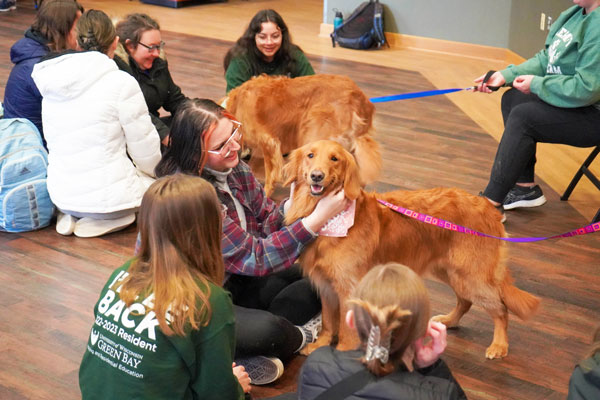 Students petting dogs at Pause for Paws event at the university union