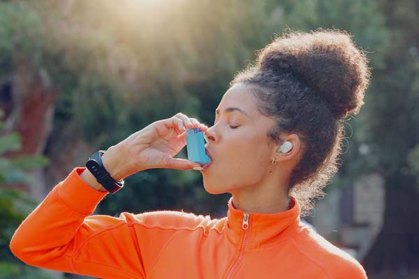 Woman using inhaler