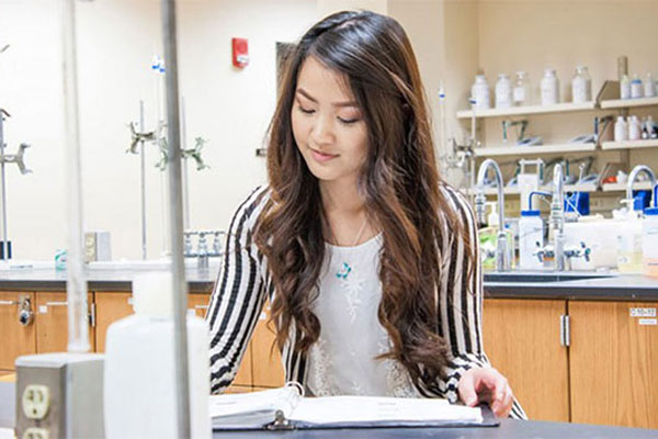 Female takes lab notes