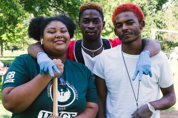 Three students pose outside