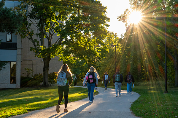 Students walk to class on a sunny day