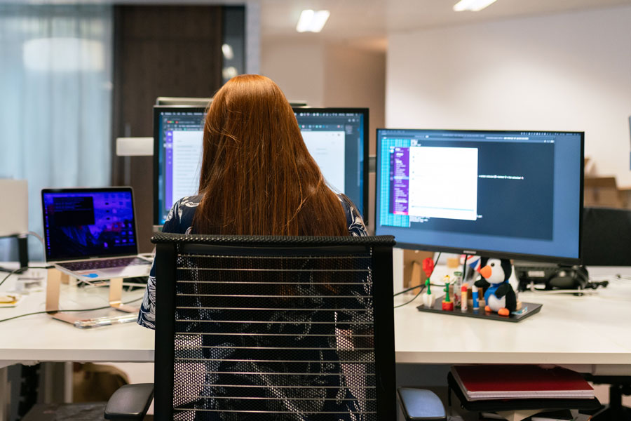 Computer Programmer working with multiple computers