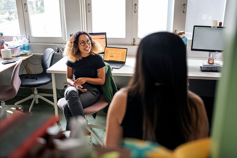 woman sitting in office meeting with another woman