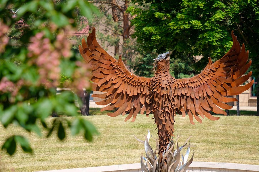 A statue of a bird with wings spread out Description automatically generated