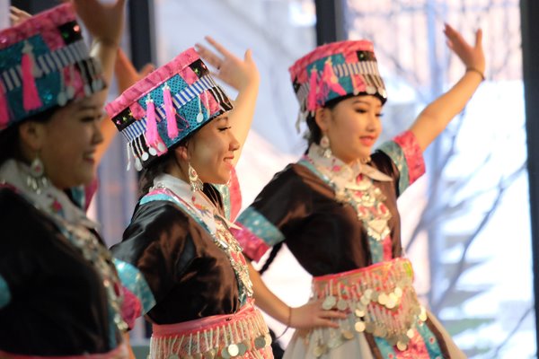 Hmong students dancing in traditional costumes