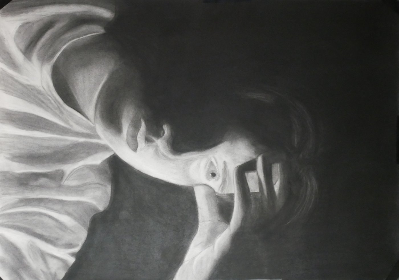 Charcoal self-portrait of a young person resting their hand on their forehead and staring into the distance.