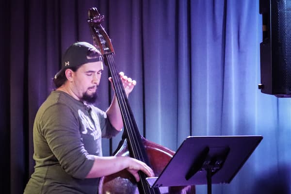 Student plays the upright bass on stage
