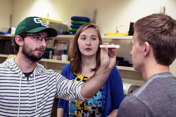 Student checks pupil dilation