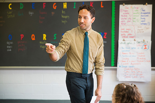 Young male teaching the english alphabet