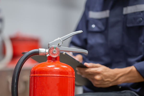 Fire Extinguisher being checked