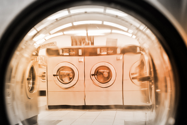 laundramat seen through the open window of a front-load washer