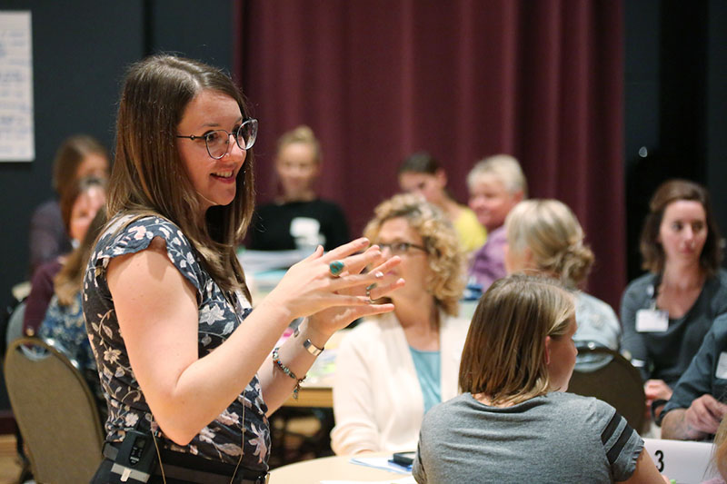 woman presenting at a conference session