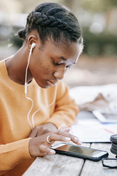 Black female student studies outdoors.