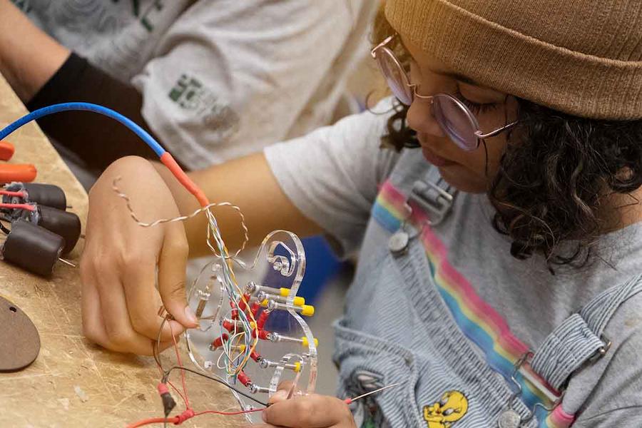 Girl working with electrical components