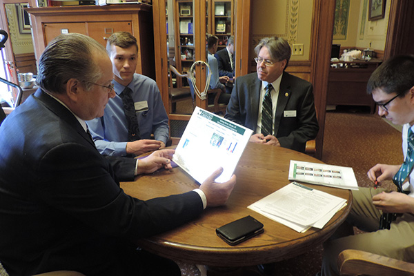 Group of men reviewing research posters in an office