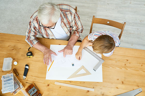 grandfather working on project with grandson