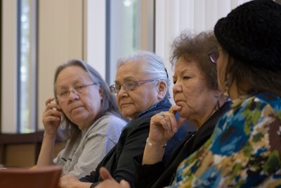 Native American elders sit together at table