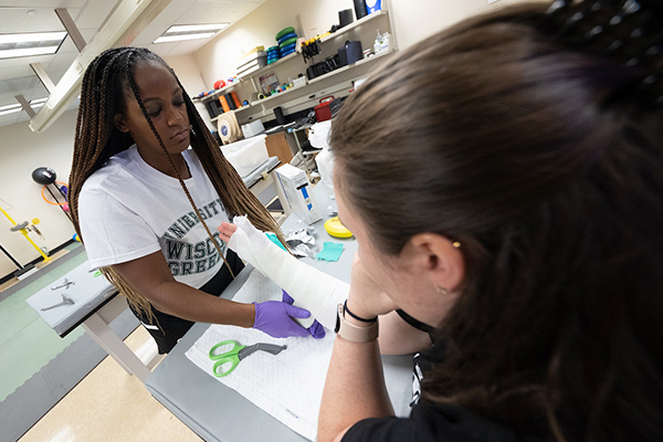 athletic trainer casting an arm