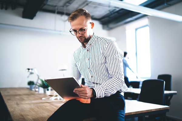 Businessman works on tablet